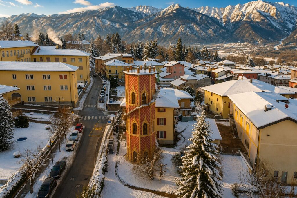 Vista aerea della Torre Belvedere immersa nella neve con le montagne del Trentino sullo sfondo